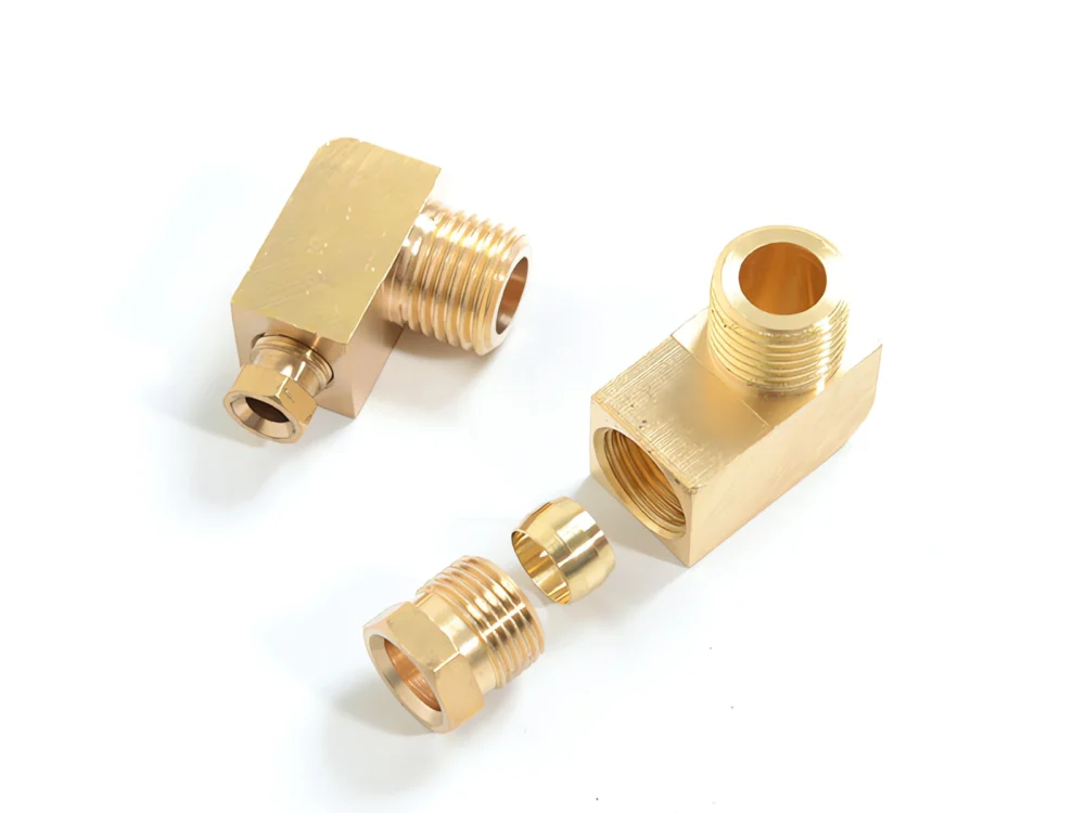 Brass pipe fittings with L-shaped connector on a white background