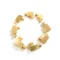 Eight brass right-angle pipe fittings are arranged in a circular pattern on a white background.